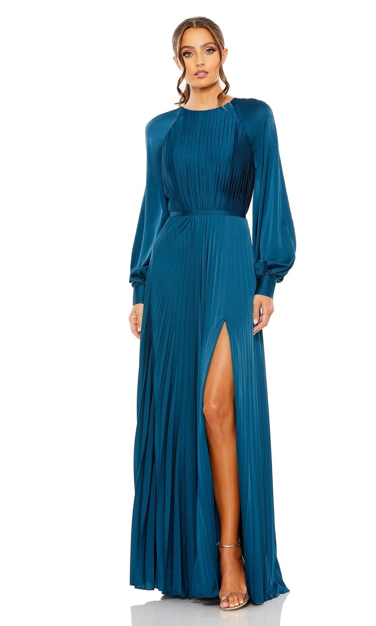 A woman stands against a plain white background wearing the Mac Duggal 26590: a teal pleated long formal dress with long sleeves and a high slit.